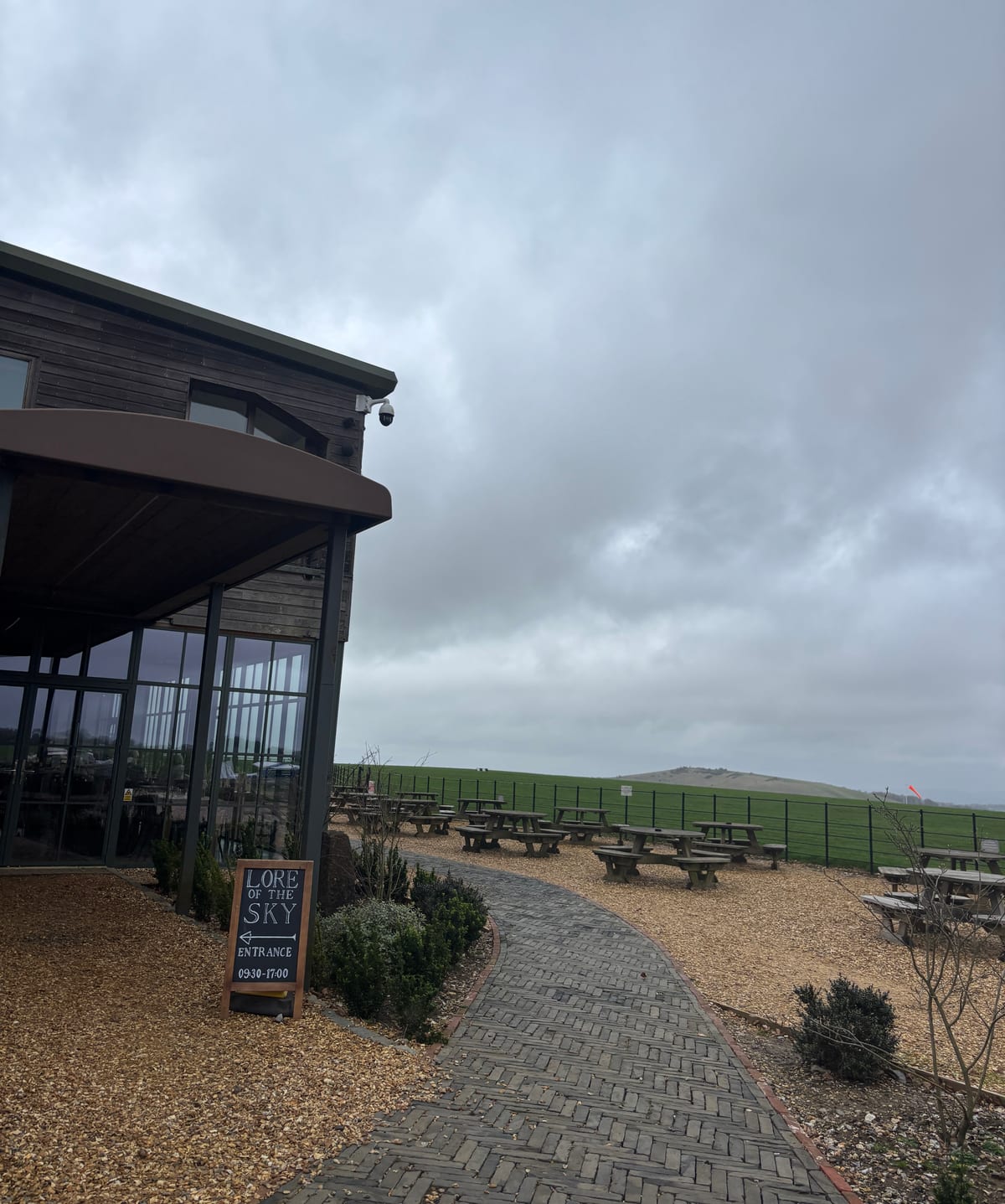 Exterior and outdoor seating of The Lore of the Sky restaurant, showing the view of the airfield.