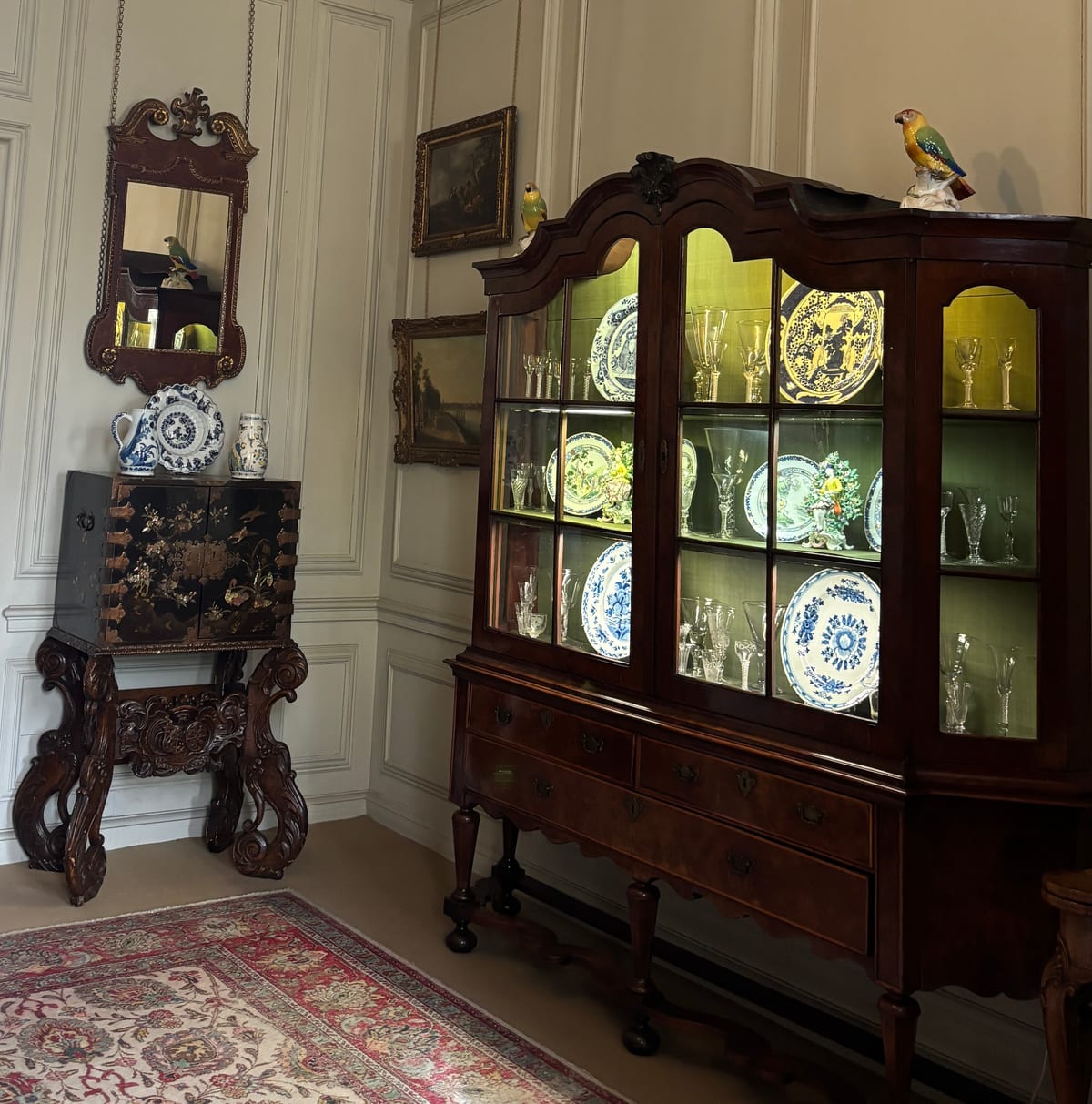 A cabinet filled with a glass and china collection in Mompesson House