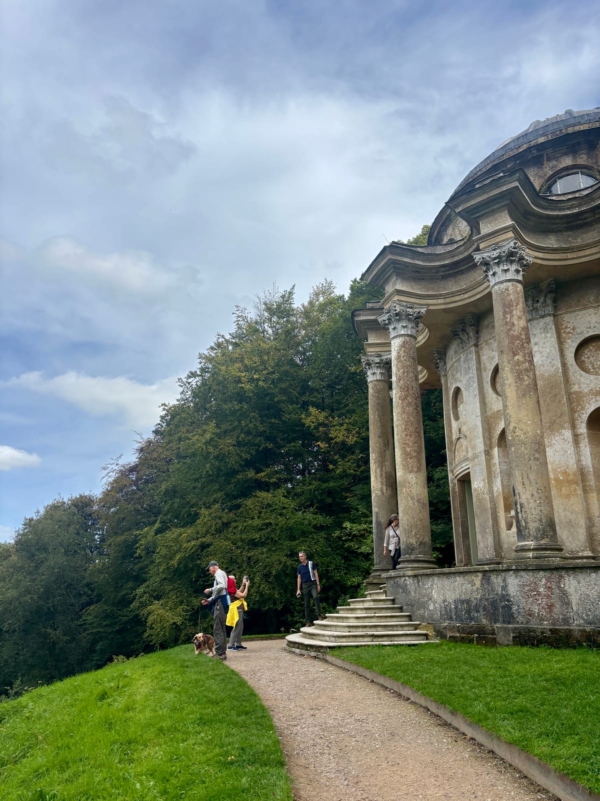 Visitors entering the front of the Temple of Apollo at Stourhead